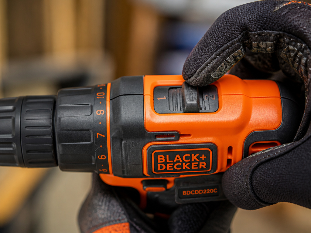 Close-up of a Black & Decker drill's dual-range gear shift button being selected.